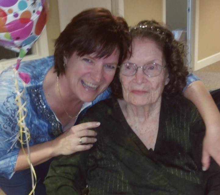 A woman and an older person smiling for the camera.